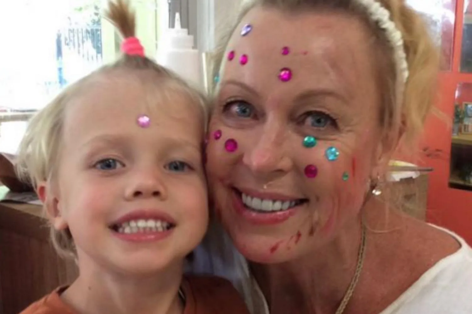 lisa curry grandson flynn mother's day with makeup and rhinestones on their faces