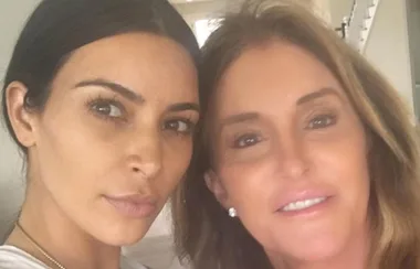 Two people taking a close-up selfie indoors with neutral expressions.