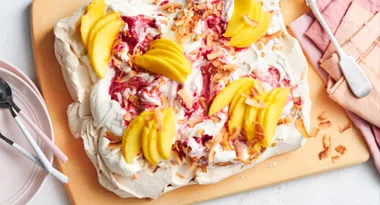 Coconut pavlova with raspberry cream and mango