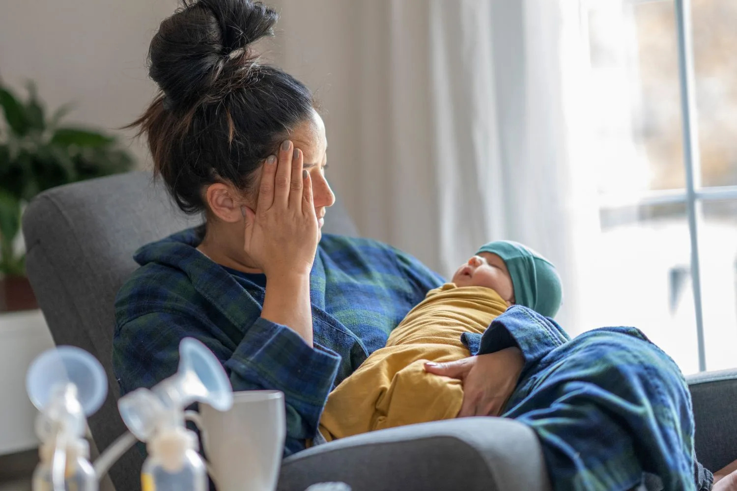 woman holding new born baby