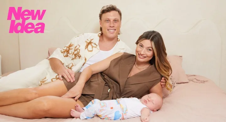 Survivor star shonee and husband lying on bed with their baby