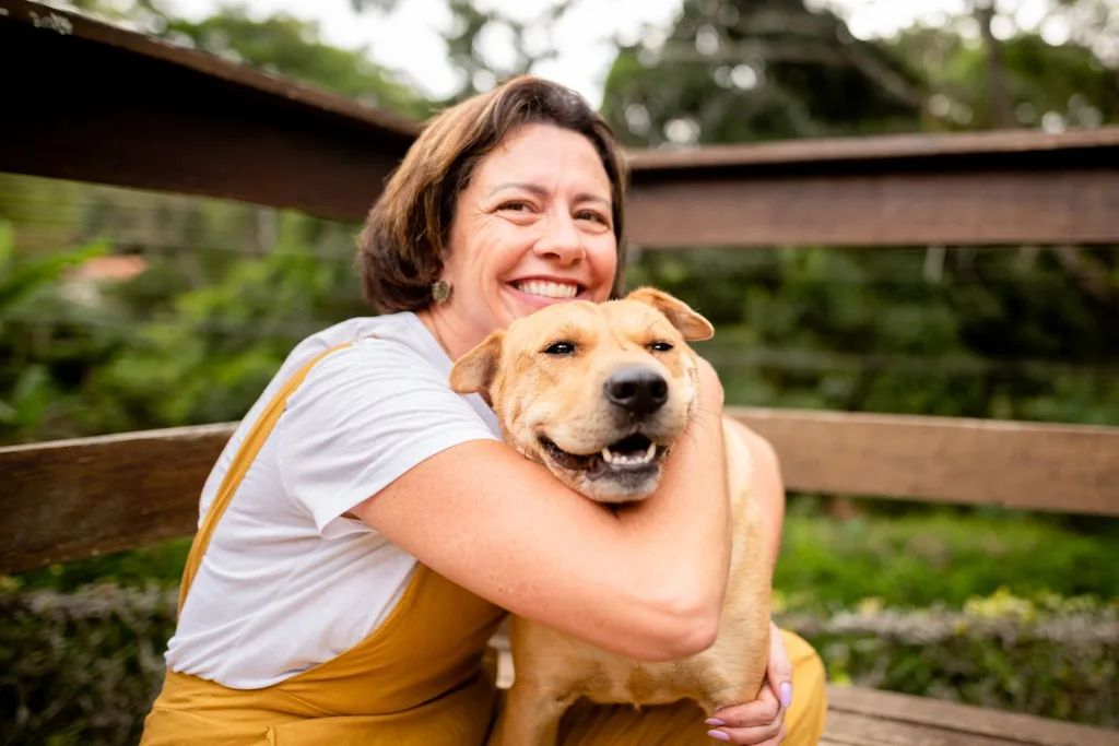 image of woman cuddling dog