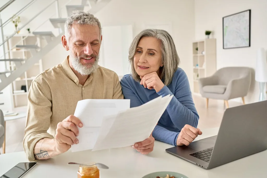 images of couple looking at finances together over computer