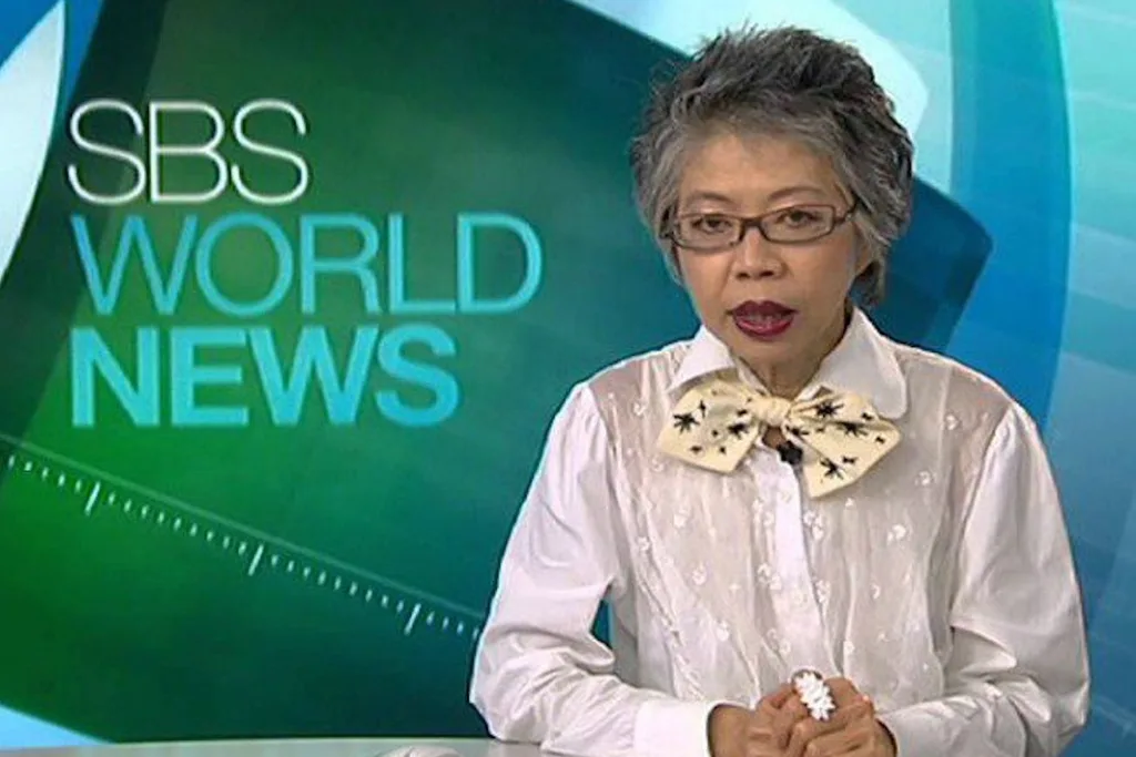 Lee Lin Chin reading the news on SBS World News.