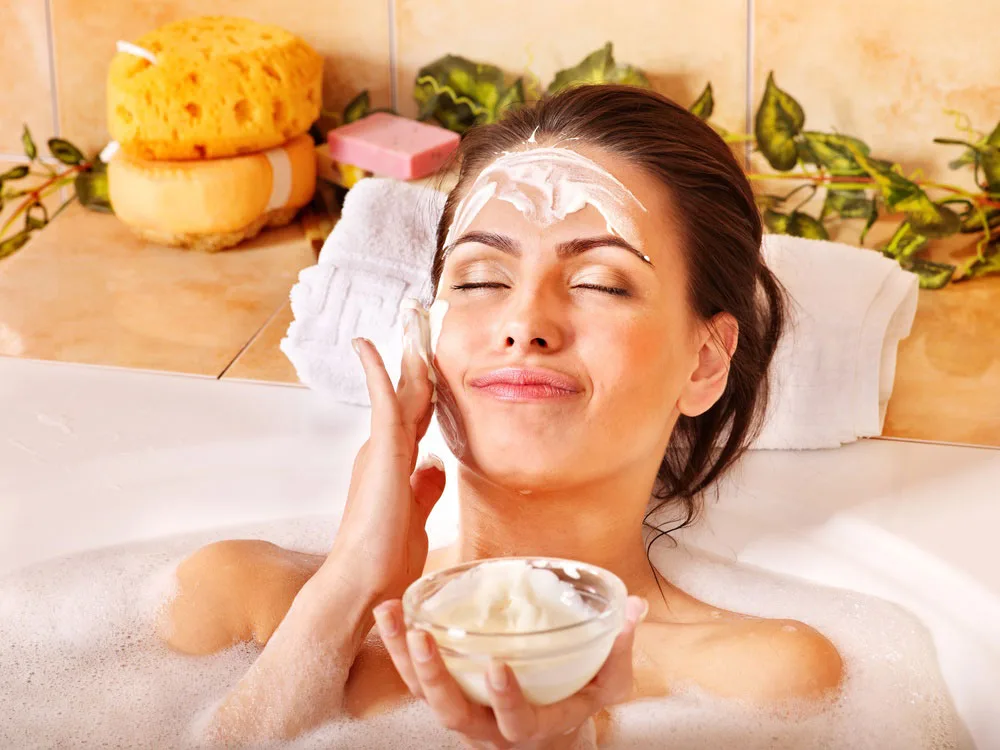 Woman in bath with facial