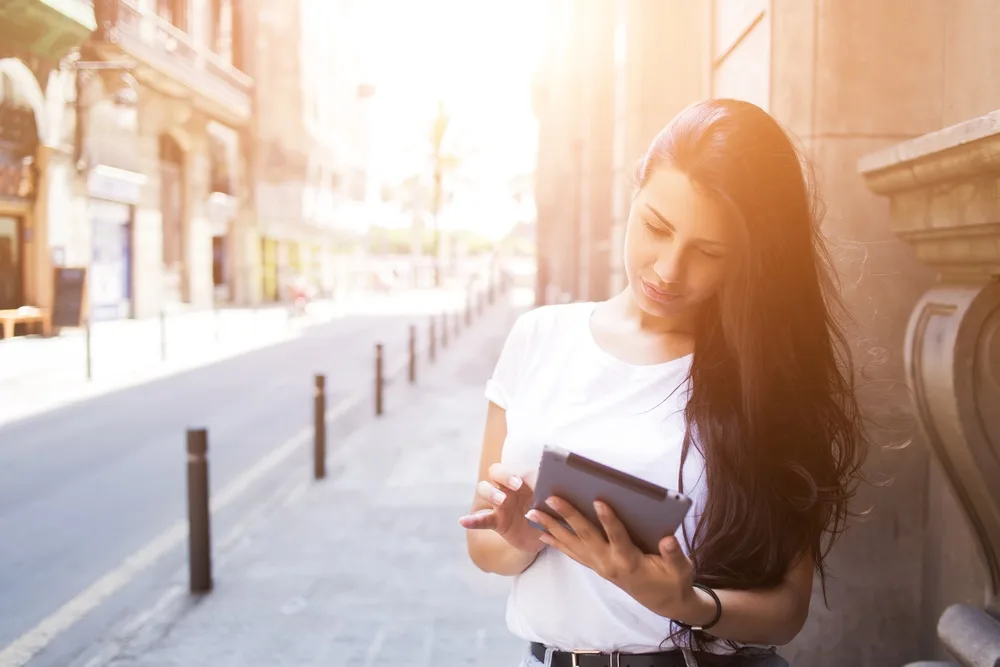 Woman on iPad in the street