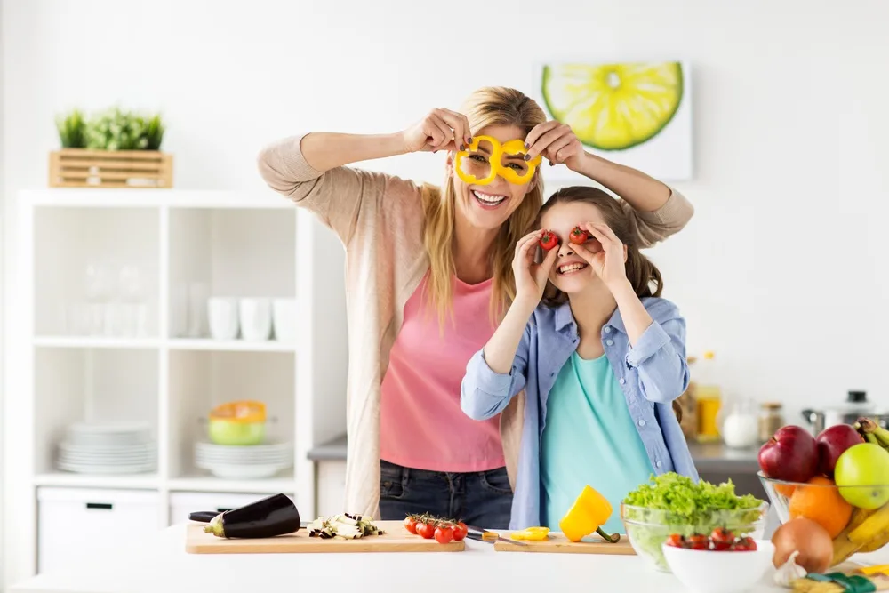 Mother and daughter playing with fruit