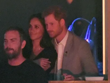 Harry and Meghan kiss and cuddle in public for first time