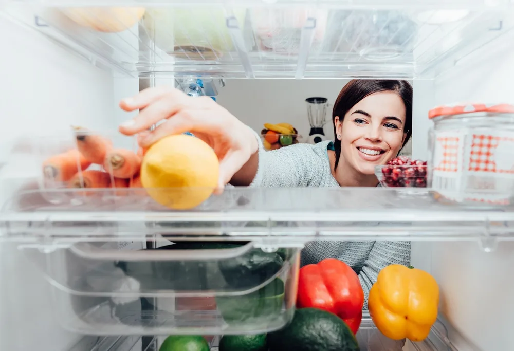 Woman rearranging fridge