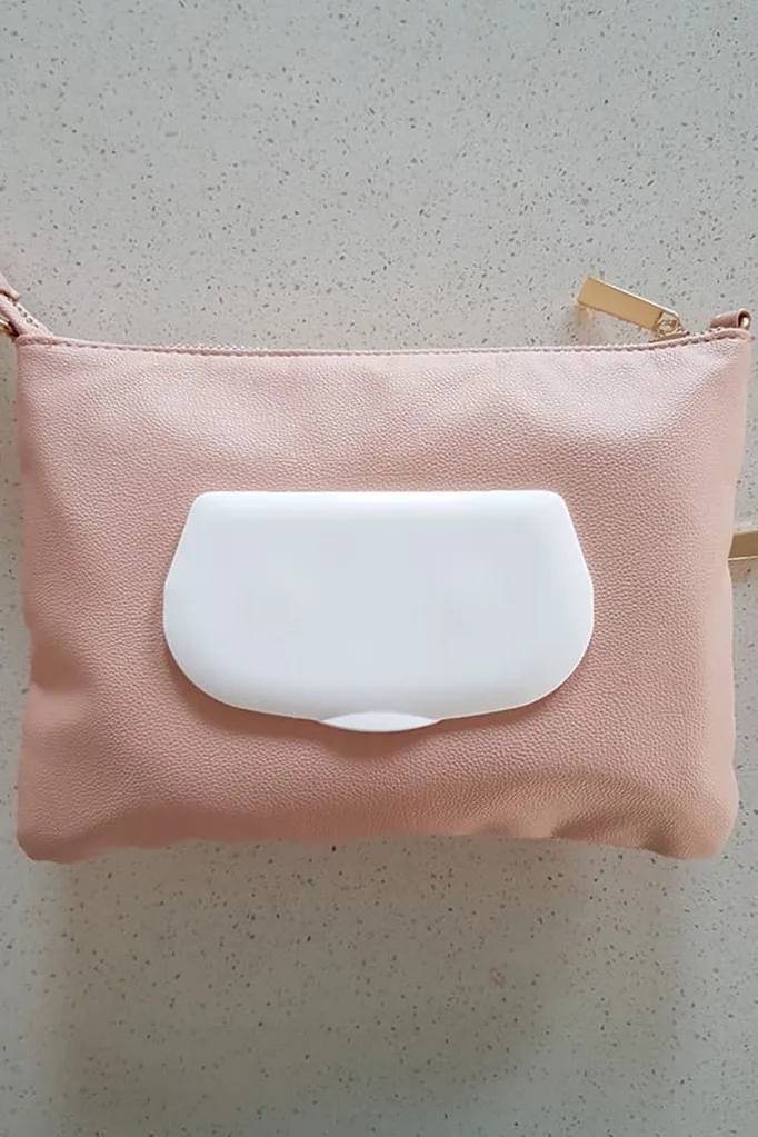Cara glued the lid of a nappy wipes dispenser to the front of the clutch.