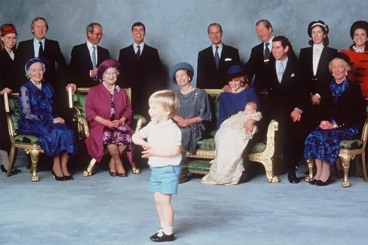 Queen Elizabeth II, Princess Diana holding Prince Harry and Prince Charles all pose at their second son's christening alongside other members of the royal family in 1984
