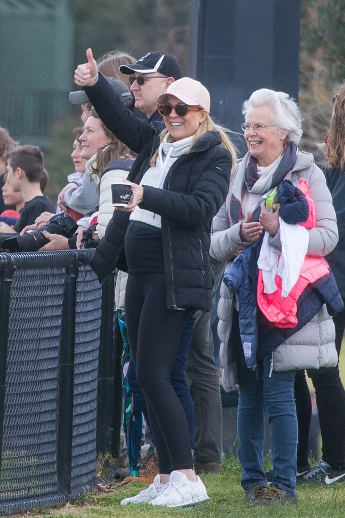 Pregnant Carrie Bickmore cheers on son at football