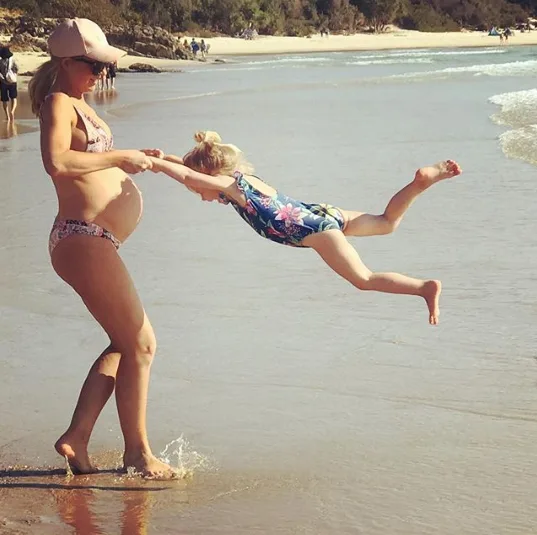 Pregnant Carrie Bickmore shows off baby bump in bikini