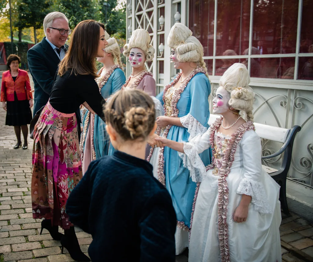 Princess Mary attends theatre with children while Prince Frederik plays golf