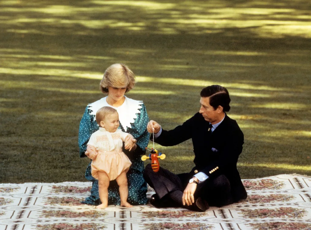 The Prince and Princess of Wales with Prince William on a rug