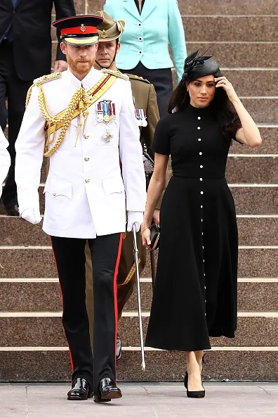 “Meghan chose a long maxi dress by Martin Grant. It suits the beach vibes and bold vertical stripes are really trending at the moment,” Donny told New Idea. Opting for the same colour scheme again, Meghan attended the official opening of the ANZAC Memorial in Sydney on Oct. 20 in a black Emilia Wickstead dress with white buttons.