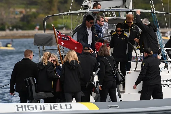 Caring prince harry holds meghan markle hand sailing sydney