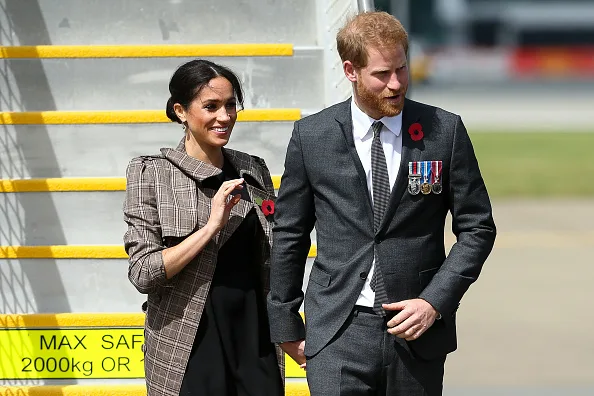 Prince Harry, Duke of Sussex and Meghan, Duchess of Sussex meet Prime Minister Jacinda Ardern as they arrive at the Wellington International Airport Military Terminal