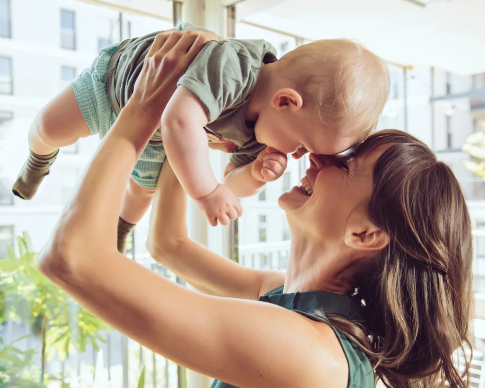 mother and baby laughing