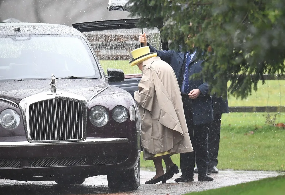 The Queen braves the rain for church