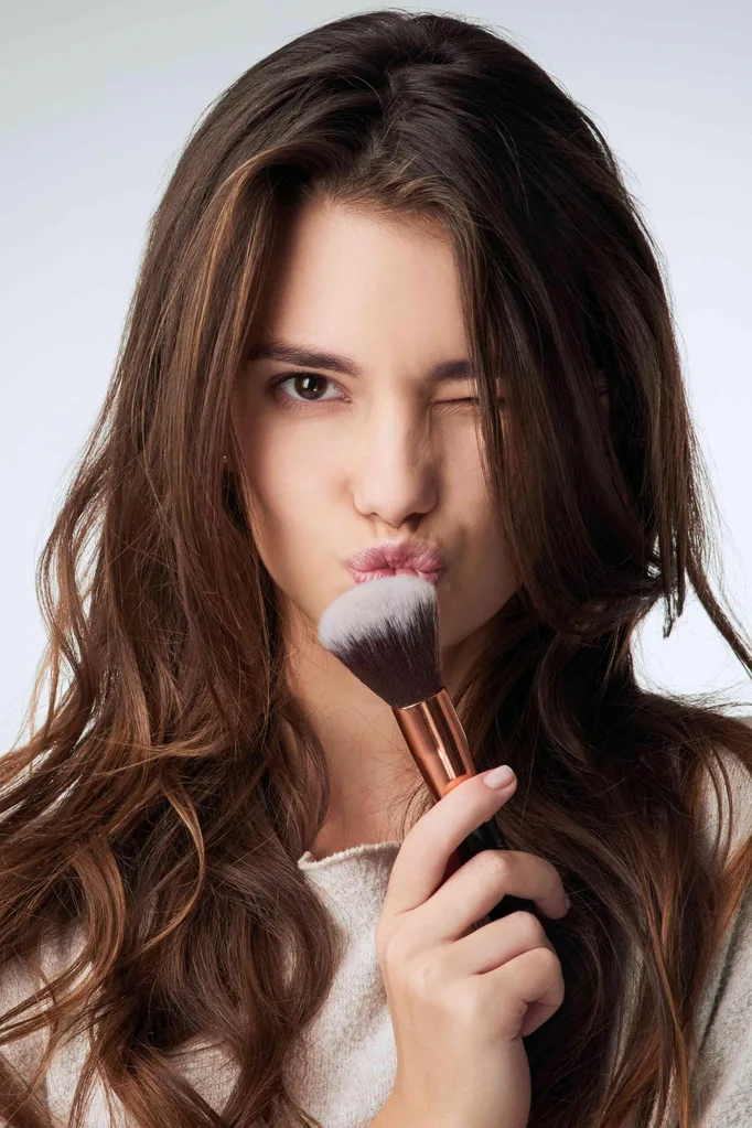 Woman with makeup brush