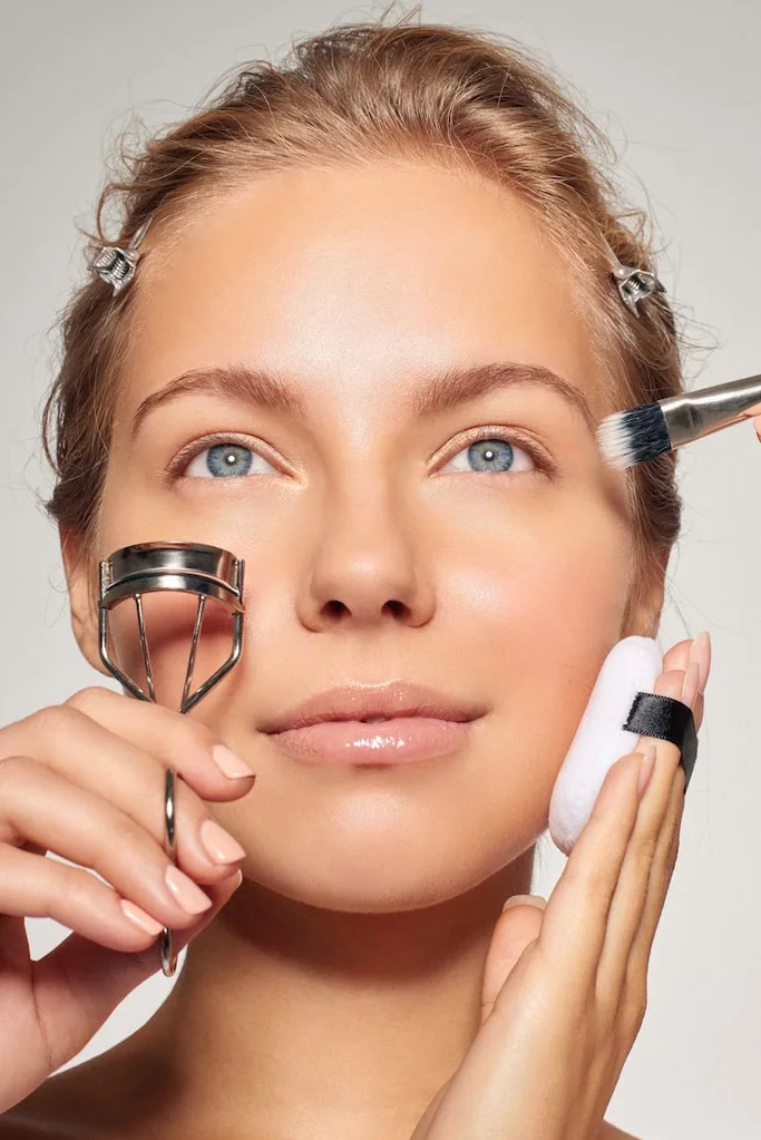 Woman applying makeup