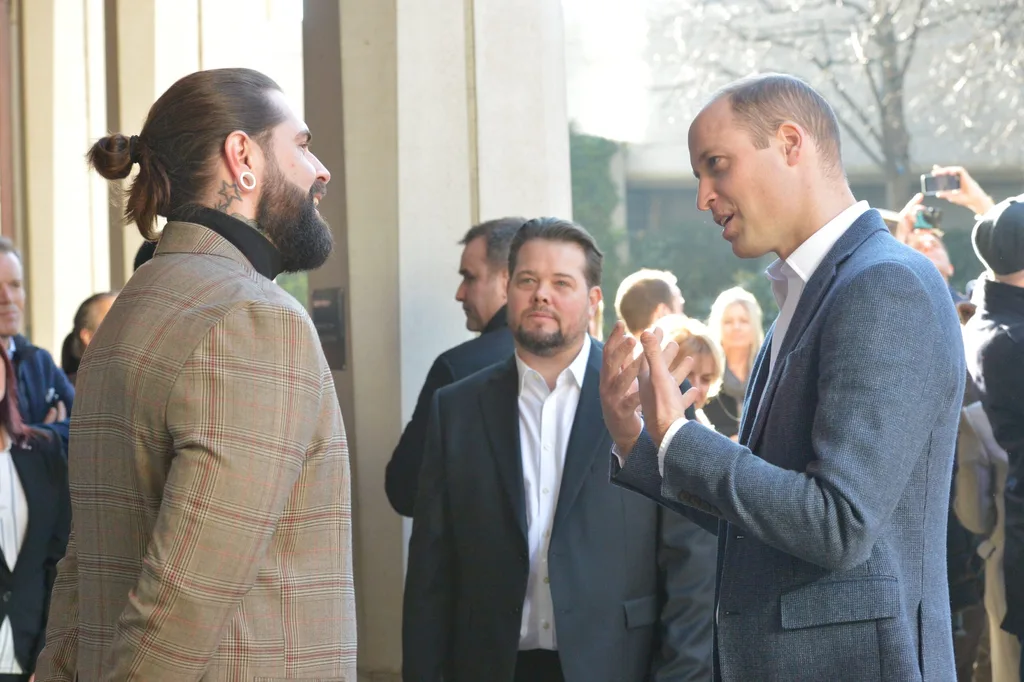 William speaks to men during the visit