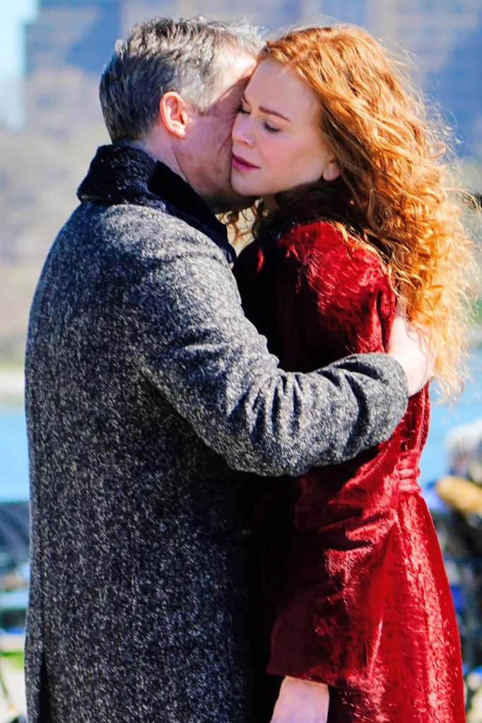 Hugh holds Nicole tight for a kiss.