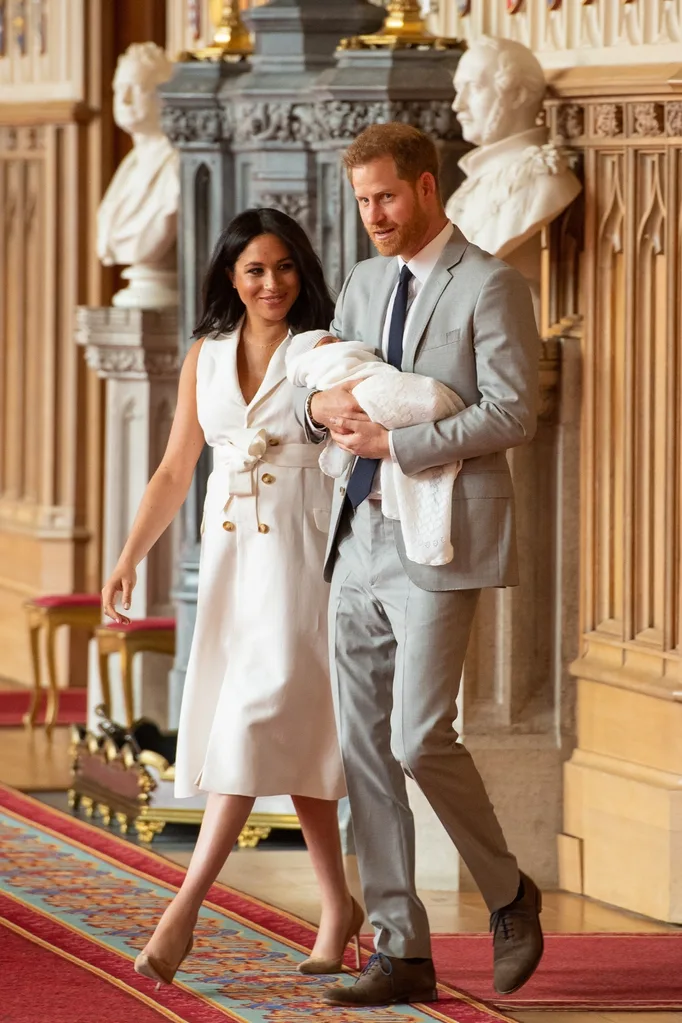 Prince Harry, Duke of Sussex and Meghan, Duchess of Sussex, pose with their newborn son during a photocall in St George's Hall at Windsor Castle