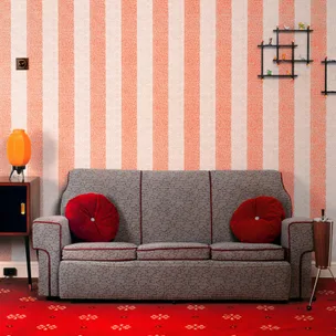 Grey retro sofa with red cushions