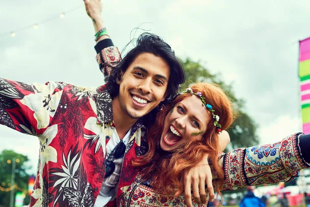Two festival goers dressed in hippie attire