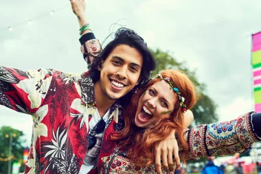 Two festival goers dressed in hippie attire