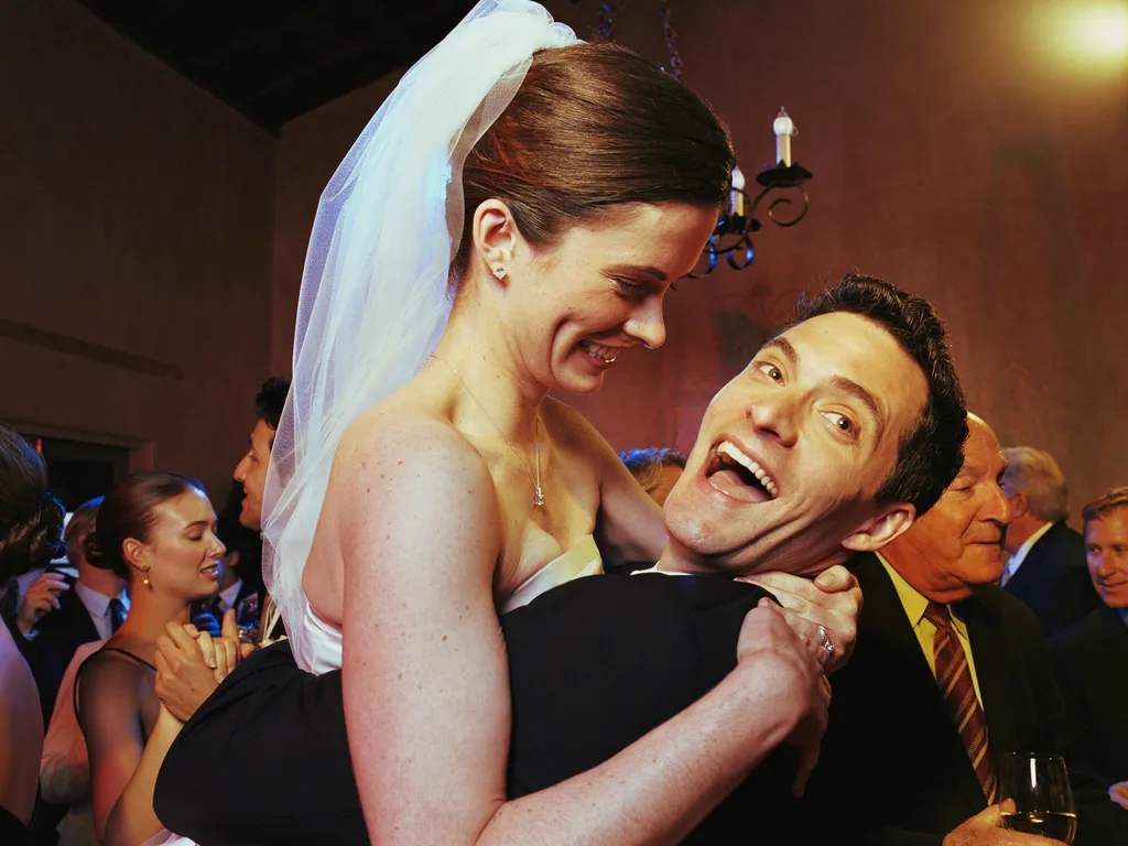 A newlywed couple dancing together