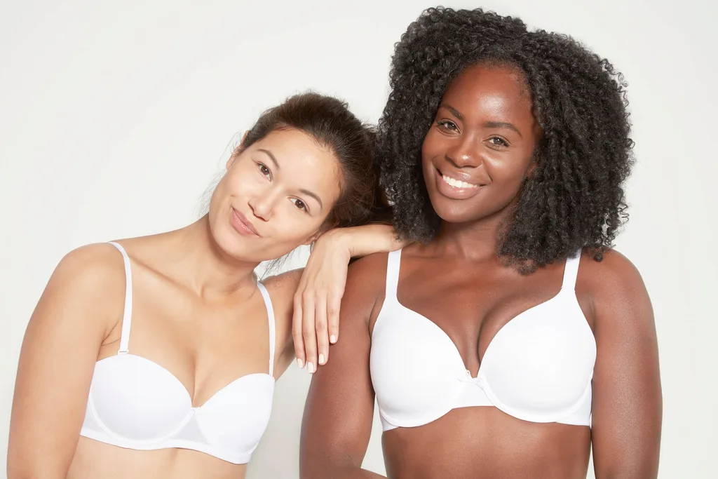 2 girls in bras on grey background