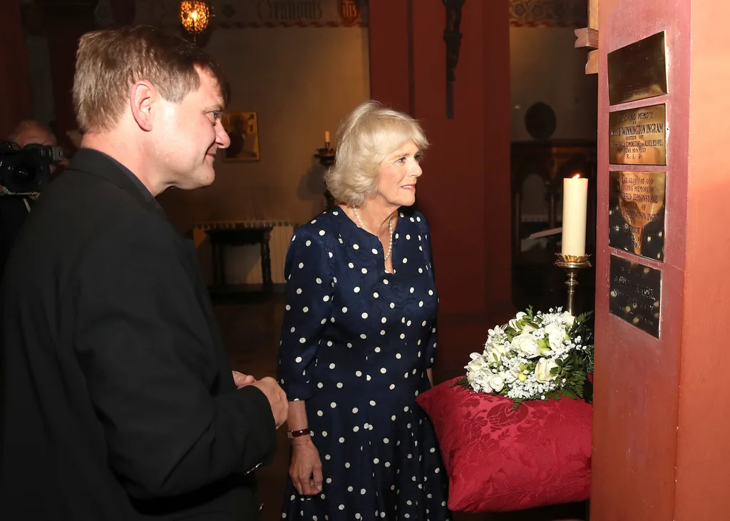 Camilla inspects a plaque her great-grandmother Alice Keppel