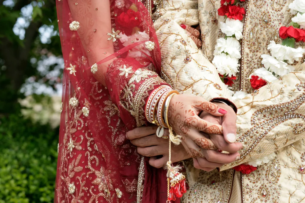 A bride with henna tattoo on her arm and hand