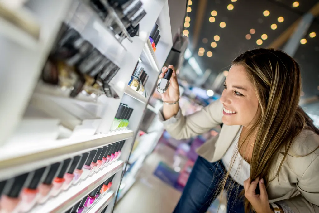 A woman buying cosmetics in a duty-free area in an airport