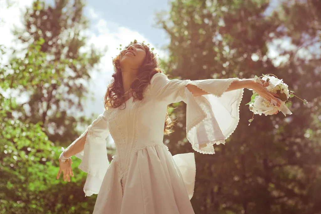 A woman spinning around in a boho styled wedding dress