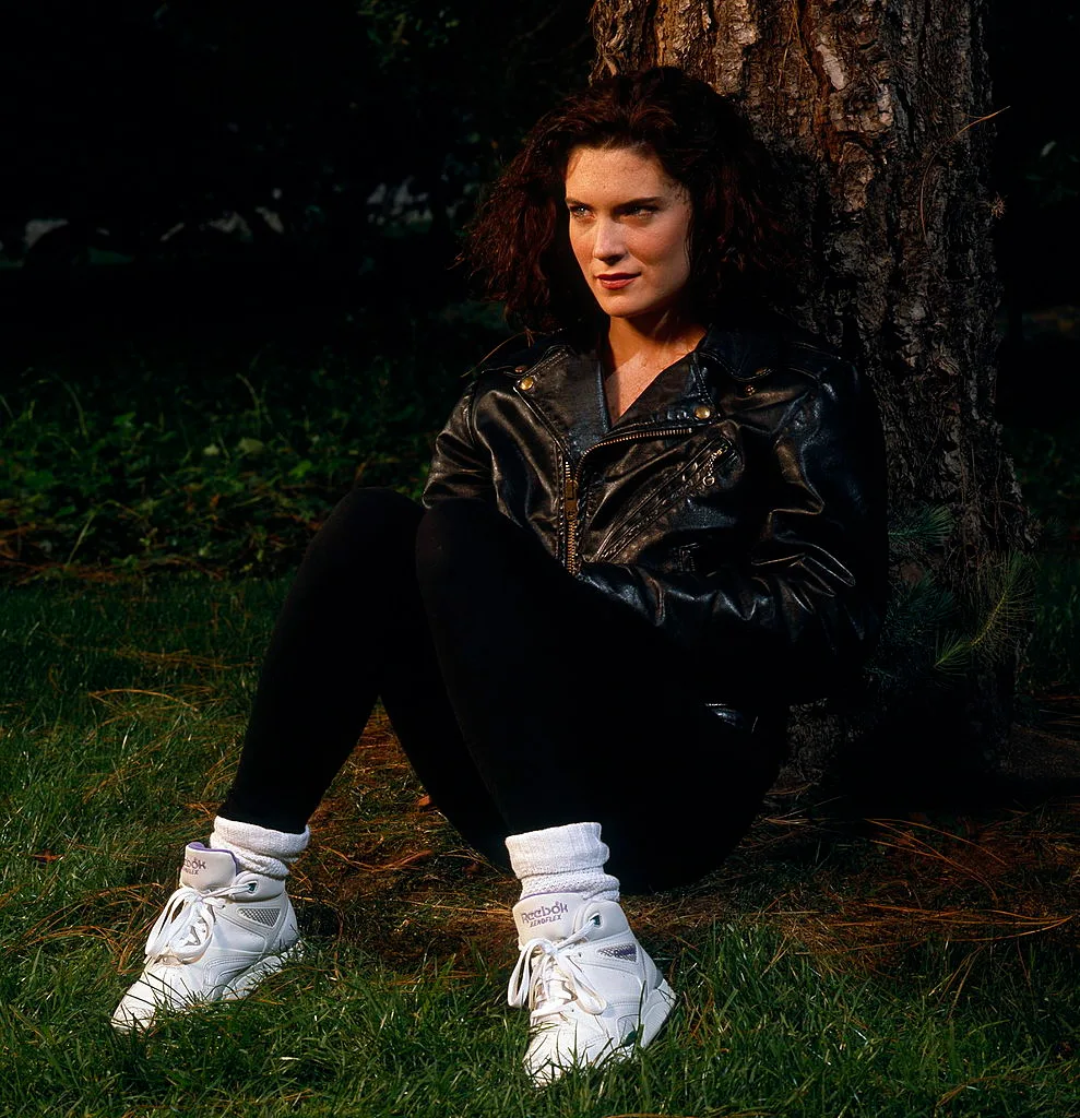 Girl wearing a 90s styled jacket and shoes