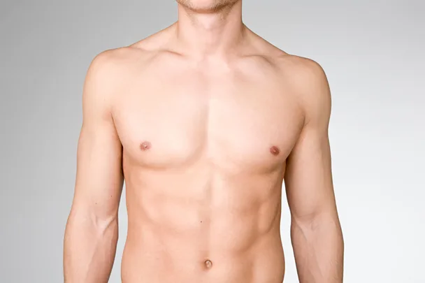 Male upper torso against a grey background