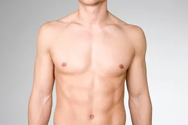 Male upper torso against a grey background