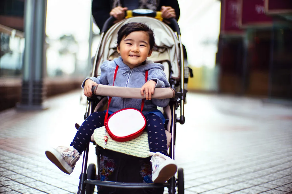 Toddler in pram smiling at camera