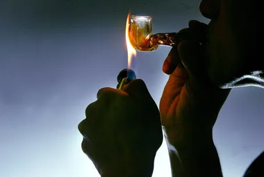 A man smoking a Meth Drug Pipe