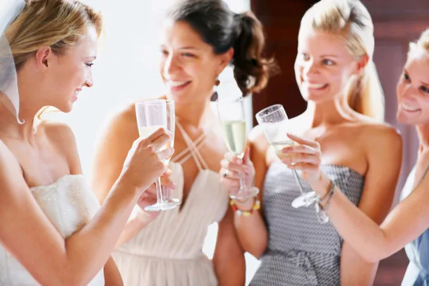 A group of bridesmaid drinking champagne