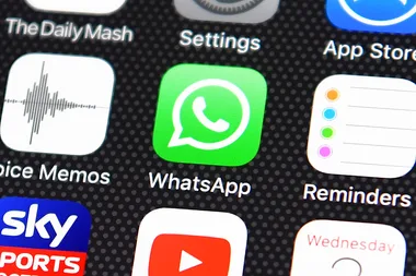 An iPhone home screen showing the WhatsApp app