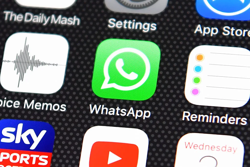 An iPhone home screen showing the WhatsApp app