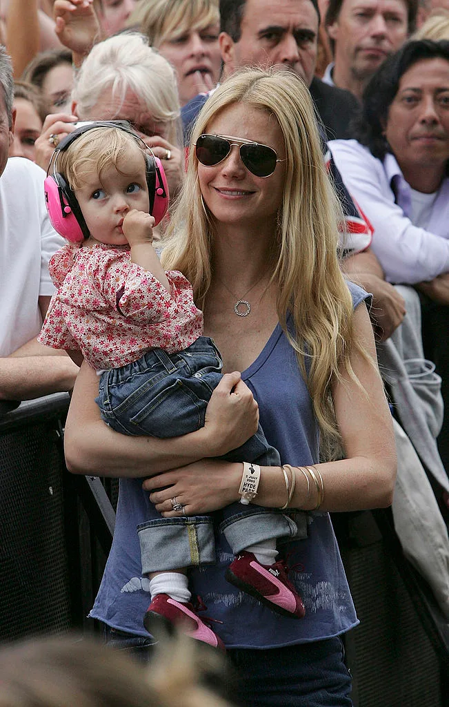 Gwyneth Paltrow holding her daughter Apple at the Live 8 London event while Coldplay performed