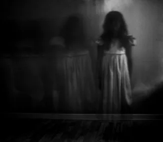 A black and white photo of a girl female ghost