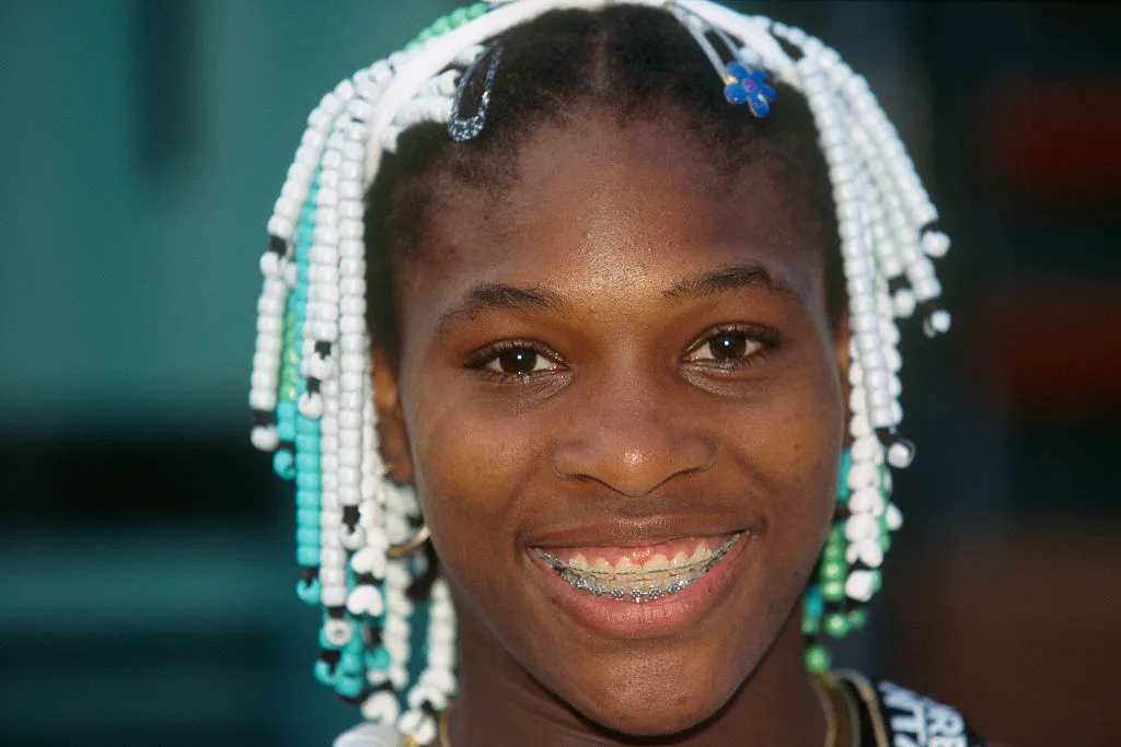 A close up portrait of a smiling Serena Williams at the 1998 French Open