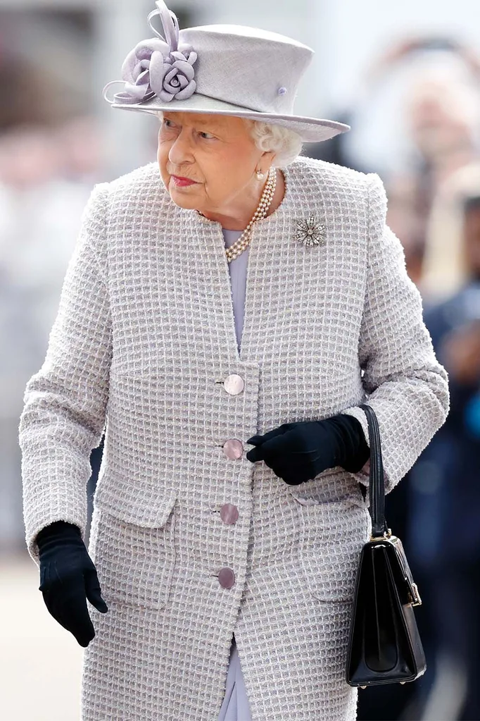 Queen Elizabeth II carries handbag
